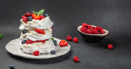 Wall Mural - Pavlova cake with berries with topping with whipped cream and strawberries. culinary, bakery, food concept