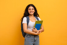 Positive Indian Woman Student Holding Notebooks Looking At Copy Space