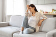 © Prostock-studio - Depression Concept. Portrait Of Sad Young Woman Sitting On Couch At Home