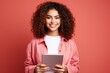 © fotogurme - Gen Z individual with digital tablet isolated on a vibrant coral gradient background