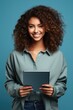 © fotogurme - Gen Z leader brainstorming over digital tablet energizing blue background with empty space for text