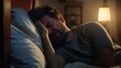 © OKAN - A man having trouble sleeping in bed.