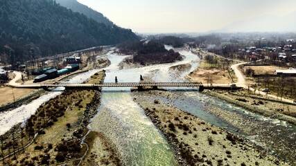 Sticker - Drone view over a bridge over a River in Pahalgam, Kashmir, India with cloudy sky