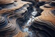 Erosion patterns revealing intricate layers of soil and rock on a riverbank