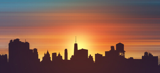 Wall Mural - New York City downtown skyline buildings silhouetted against the colorful sky with the light of sunset in the background