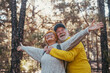 © Daniel - Head shot portrait close up of one old mature couple looking at the trees enjoying nature alone in the forest.Pensioner people with opened arms feeling free, freedom concept..