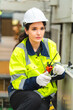 © chokniti - Portrait female professional engineer factory in protective uniform operating machine, Engineering worker in safety hardhat at warehouse industrial facilities, Heavy Industry Manufacturing