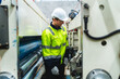 © chokniti - professional technician engineer with safety helmet hard hat working in industrial manufacturing factory, men at work to checking equipment of machinery production technology or construction operating