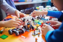 Children Enthusiastically Assemble Detailed Construction Kit With Bright Details Of Constructor. Group Of Children Using Imagination Assembled From Designer Parts Of Toy To Play