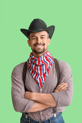 Wall Mural - Handsome cowboy on green background