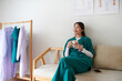 © DragonImages - Happy nurse resting on couch in lounge area and drinking cup of tea or coffee