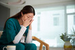 © DragonImages - Young nurse crying after difficult day at work