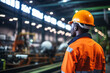 African men mechanical engineer, wearing safety equipment, While operate machine on production line and safety control while work inside of factory area, With blurred background of heavy machine