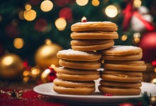 A Stack Of Sugar Cookies Sitting On A Plate Next To A Christmas Tree