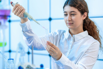 A female scientist doing medical research in a chemistry lab.