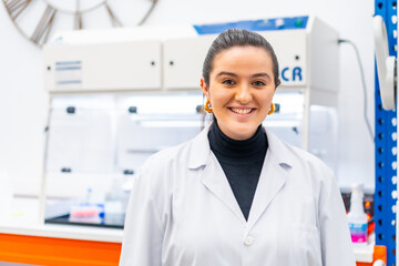 Wall Mural - young scientist standing smiling in a laboratory
