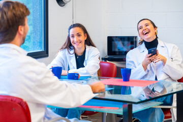 Wall Mural - scientists sitting and chatting during a coffee break
