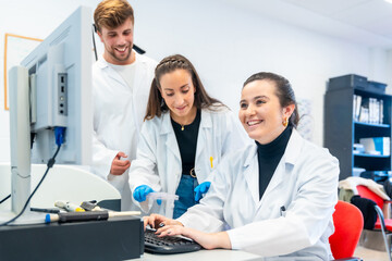 Wall Mural - three young doctors working in a scholarship in a laboratory
