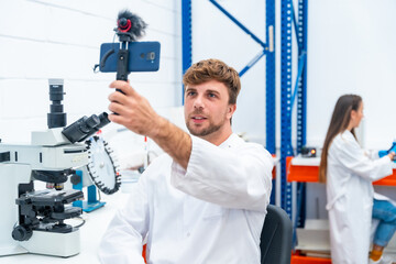 Wall Mural - scientist recording a video using phone inside a research laboratory