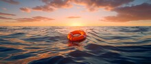 Orange Lifebuoy Floating At Sea Sunset Sunrise, Wide Horizontal Banner