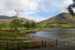 The mountain of Whiteless Pike climbs above the shore of Buttermere in the Lake District