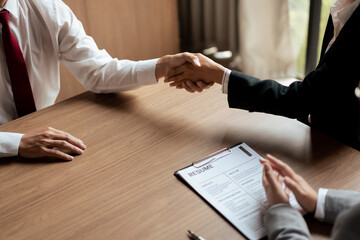 Wall Mural - HR manager woman shaking hand and congratulation with male candidate after successful interviewing