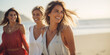 © radekcho - Group of female friends enjoy taking a walk together on the beach. Woman friends walking on the sea shore. Multiracial young women strolling along a beach.
