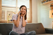 © Prathankarnpap - Smiling caucasian woman in casual outfit having phone conversation with friends or lover