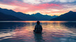 Silhouette of person sitting in the water in front of mountains in the middle of nature