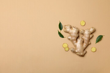 Wall Mural - Fresh ginger root with leaves on a light background
