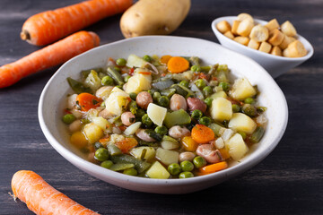 Wall Mural - Vegetable and legume minestrone served with croutons. Complete vegan dish ideal for lunch and dinner. Italian minestrone.