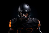 Fototapeta  - Studio portrait of professional American football player in black uniform. Determined, powerful, skilled African American athlete wearing helmet with protective mask. Isolated in black background.