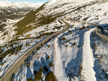 Aerial View Of A Curvy Road In The Snowy Mountains In The Winter In Andorra