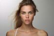 © lucky pics - Attractive young adult Caucasian woman on grey background. Neural network generated photorealistic image.