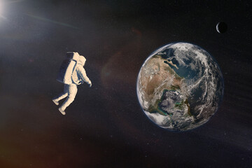 Wall Mural - cosmonaut in outer space against earth planet. elements of this image furnished by nasa.
