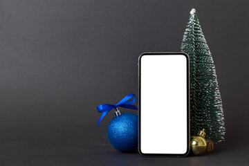 Wall Mural - Digital phone mock up with rustic Christmas decorations for app presentation with empty space for you design. Christmas online shopping concept. Tablet with copy space on colored background