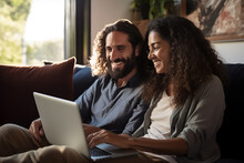 Man and woman sitting on the couch with a laptop PC and doing online shopping or streaming a movie - Topic online and streaming services