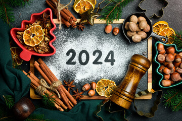 Wall Mural - Kitchen slate board. Inscription with flour on a board 2024. New Year's card. Top view. Flat lay.