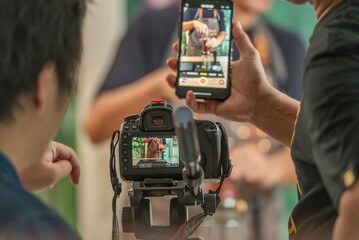 back screen video recording by videographer record video clip by camera and smartphone to online social internet live. vlogger watching recording clip streaming online a man make a cup of coffee drip