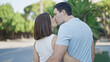 © Krakenimages.com - Beautiful couple hugging each other standing backwards kissing at park