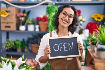 Poster - Young hispanic woman working at florist holding open sign smiling with a happy and cool smile on face. showing teeth.