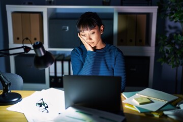 Wall Mural - Young beautiful woman working at the office at night thinking looking tired and bored with depression problems with crossed arms.