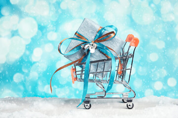 Wall Mural - Shopping cart with wrapped gift. Preparation for the New Year and Christmas, shopping, boxing day.