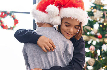 Poster - Adorable boys hugging each other celebrating christmas at home