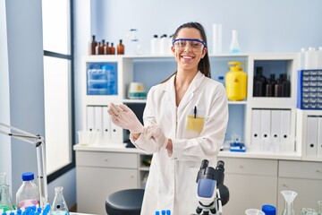 Sticker - Young beautiful hispanic woman scientist smiling confident wearing gloves at laboratory