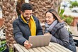 © Krakenimages.com - Man and woman couple using laptop drinking coffee at coffee shop terrace