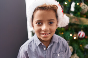 Canvas Print - Adorable hispanic boy smiling confident standing by christmas tree at home