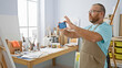 © Krakenimages.com - Handsome bearded caucasian man artist snapping smartphone photo to draw painting at artsy indoor studio