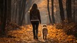 woman walking with her dog in autumn  park