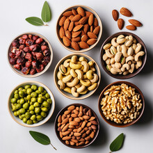 Mix Of Nuts In Bowls On A White Background. Top View.